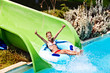 Child on water slide at aquapark.
