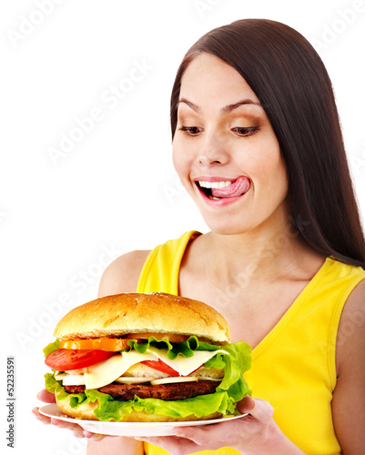 Photo: Woman holding hamburger. Woman holding hamburger.
