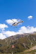 Transport helicopter fly over mountain wilderness