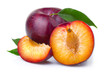 Ripe purple plum fruits with green leaves isolated