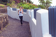 Photo: Young woman running through an urban path Young woman running through an urban path