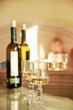 Glass of white wine and a bottle on the table