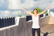 Happy woman standing with outstretched arms