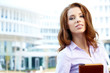 Attractive business women over modern street background