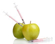 green apples and syringes isolated on white