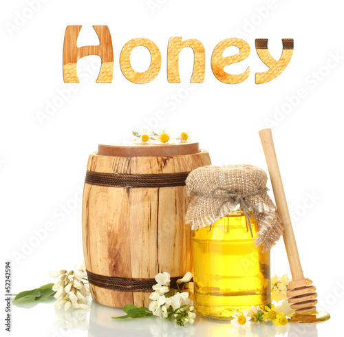 Photo: Sweet honey in jar and barrel with acacia flowers isolated Sweet honey in jar and barrel with acacia flowers isolated