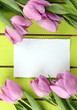 Photo: Beautiful bouquet of purple tulips and blank card Beautiful bouquet of purple tulips and blank card