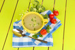 Photo: Diet soup with vegetables in cup on green wooden table close-up Diet soup with vegetables in cup on green wooden table close-up