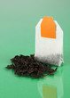 Tea bag on green background
