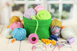 Colorful yarn for knitting in green basket