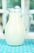 Pitcher of milk on table in room