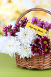 Bouquet of beautiful chrysanthemums in wicker basket
