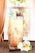 Delicious fruit smoothie on window background