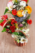 Many different flowers in baskets on light background