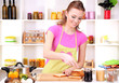 Young woman cooking in kitchen