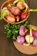 Sprouting onions on board and in basket on wooden table