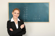 Portrait of teacher woman near chalkboard in classroom