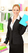 Portrait of teacher woman with book in classroom
