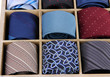 Neckties in wooden box isolated on white