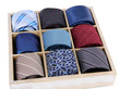 Neckties in wooden box isolated on white