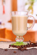 Layered coffee in glass on table on bright background