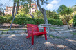 Photo: Beautiful red wooden chair on the park Beautiful red wooden chair on the park