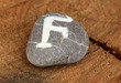 Fortune telling  with symbols on stone on wooden background