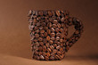 Cup of coffee beans, on brown background