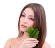 Beautiful young woman with green leafs isolated on white