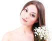 Beautiful young woman with flowers isolated on white