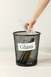 Photo: Assorted trash in bucket on room background Assorted trash in bucket on room background