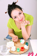 Young pretty woman working on clay sculpture, on gray