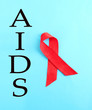 Aids awareness red ribbon on blue background