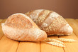 Composition with bread on wooden table, on color background
