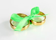 Wedding rings tied with ribbon isolated on white
