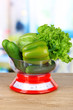Fresh vegetables in scales on table in kitchen
