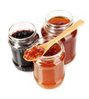 Tasty jam in banks isolated on white