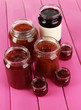Tasty jam in banks on table