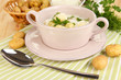 Tender young potatoes with sour cream and herbs in pan