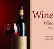 Bottle and glass with wine on dark red background