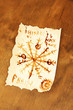 Old paper with symbols, on wooden background