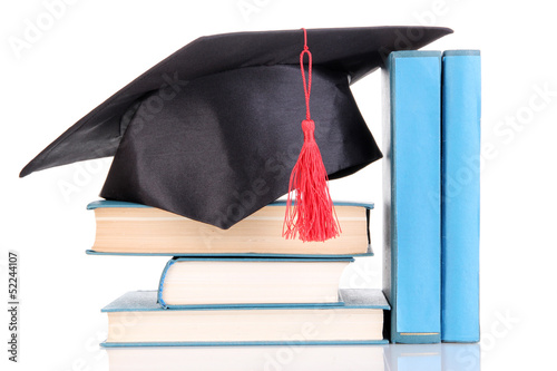Photo: Grad hat with books isolated on white Grad hat with books isolated on white