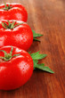 Photo: Fresh tomatoes on wooden background Fresh tomatoes on wooden background