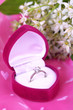 Photo: Beautiful box with wedding ring on purple background Beautiful box with wedding ring on purple background
