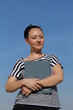 Photo: Beautiful brunette young woman outside, holding a book Beautiful brunette young woman outside, holding a book