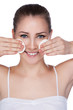 woman cleaning her pretty face with cotton swab
