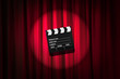 Movie clapper board against curtain