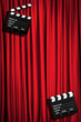Movie clapper board against curtain