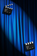 Movie clapper board against curtain