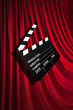 Movie clapper board against curtain